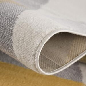 Close-up of folded gray and yellow area rug.