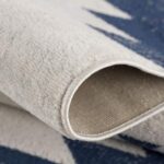 Blue and white patterned woven rug corner view.