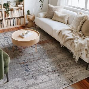 Cozy living room with beige sofa and round table.
