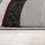 Striped carpet edge on wooden floor.