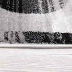 Close-up of a patterned rug edge on floor.