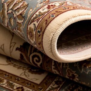 Close-up of rolled oriental rug with floral patterns.