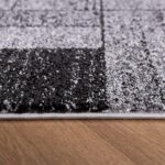 Close-up of a gray pattern carpet on wood floor.