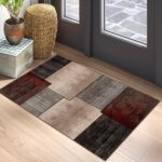 Modern geometric rug on wooden floor by door