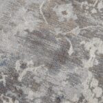 Close-up of textured gray floral carpet.