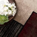 Open book and flowers on patterned carpet