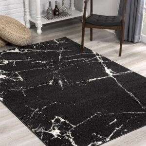 Modern black rug with white abstract pattern.
