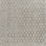 Beige rug with intricate geometric pattern.