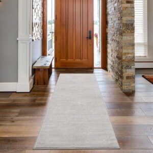 Hallway with wooden door and light runner rug.