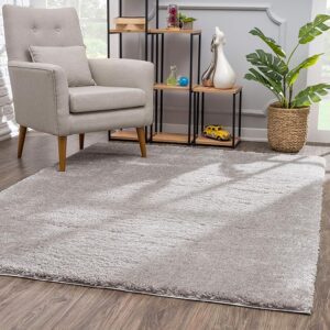 Cozy living room with gray rug and armchair.