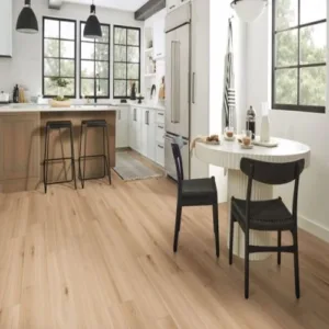 Modern kitchen with wood flooring and white cabinets.