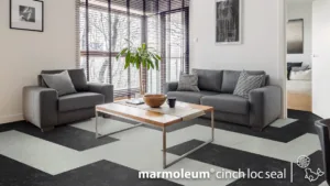 Modern living room with gray furniture and large windows.