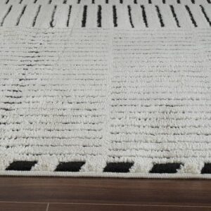 White and black patterned rug on wooden floor