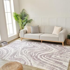 Modern living room with gray sofa and patterned rug.
