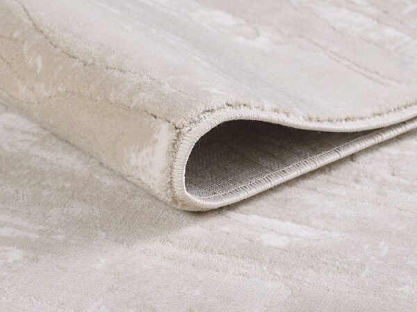 Close-up of rolled beige rug texture