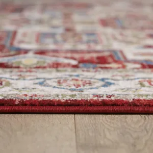 Close-up of red patterned rug on wooden floor