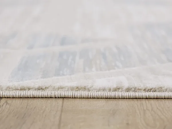 Close-up of carpet on wooden floor.