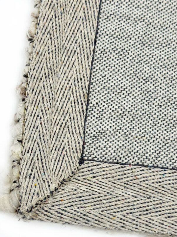 Close-up of woven fabric with fringe edge