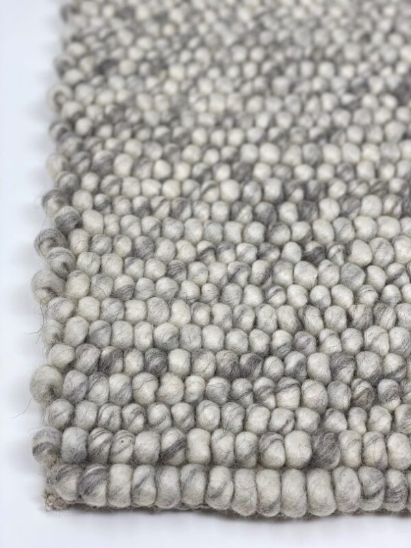 Close-up of woven wool carpet texture.