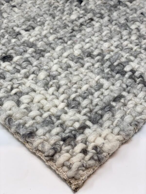 Close-up of gray woven wool rug texture.