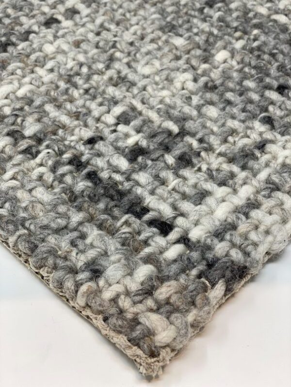 Close-up of woven gray and white rug texture