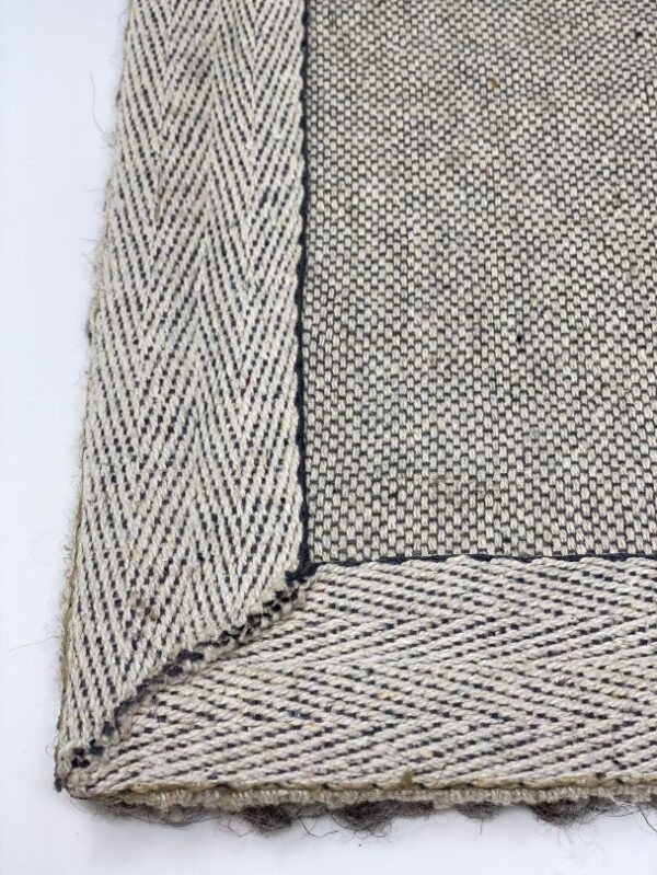 Close-up of textured woven rug corner