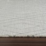 Cream rug with geometric pattern on hardwood floor