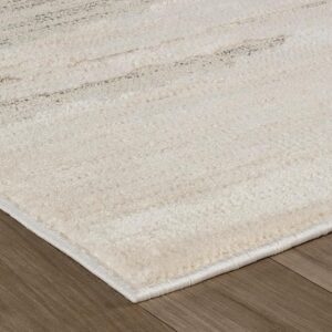 Beige shag rug on wooden floor.