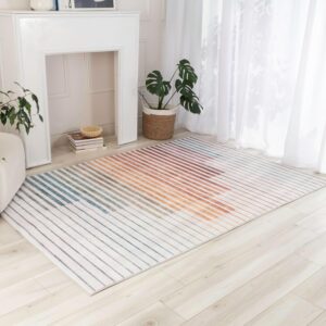 Colorful striped rug by fireplace and plants