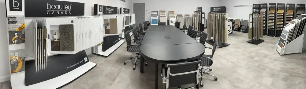 Showroom with flooring samples and conference table.
