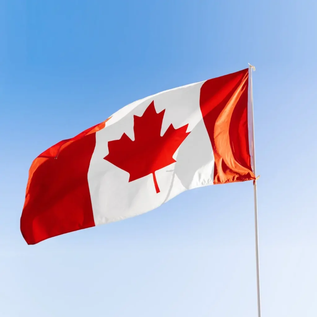 Canadian flag waving under blue sky