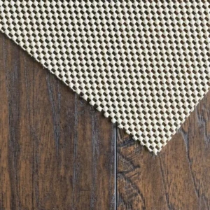 Non-slip rug pad on wooden floor