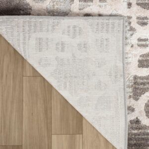 Corner of a patterned rug on wooden floor.