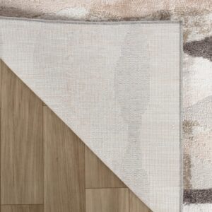 Beige and gray rug corner flipped on wood floor.